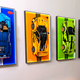 Wall display frames showcasing LEGO sports car models with colorful backgrounds
