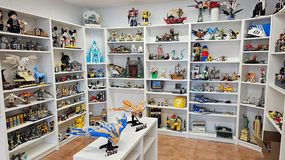 Room with white shelves displaying LEGO collectible models, cars, and figures.