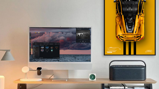 Modern workspace with desktop computer and LEGO car collectible display frame on wall