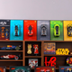 Wall display frames showcasing LEGO car models and collectibles on a wooden shelf.