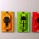 Wall display frames with LEGO sports cars on colorful backgrounds and LED lighting