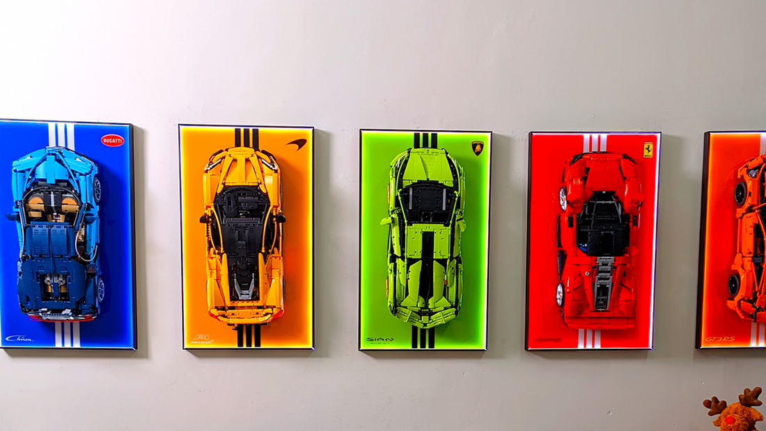 Wall display frames with LEGO sports cars on colorful backgrounds and LED lighting
